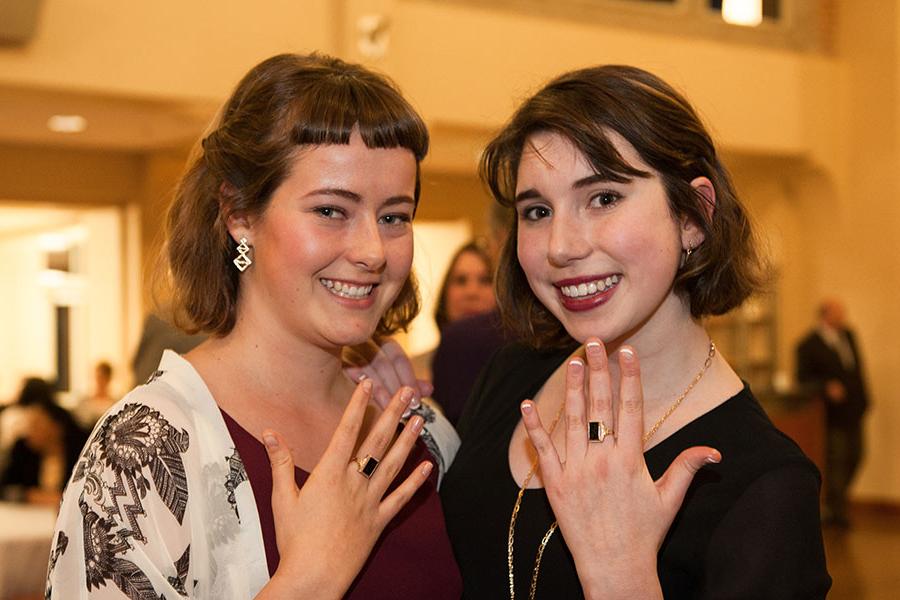 Students holding up black ring